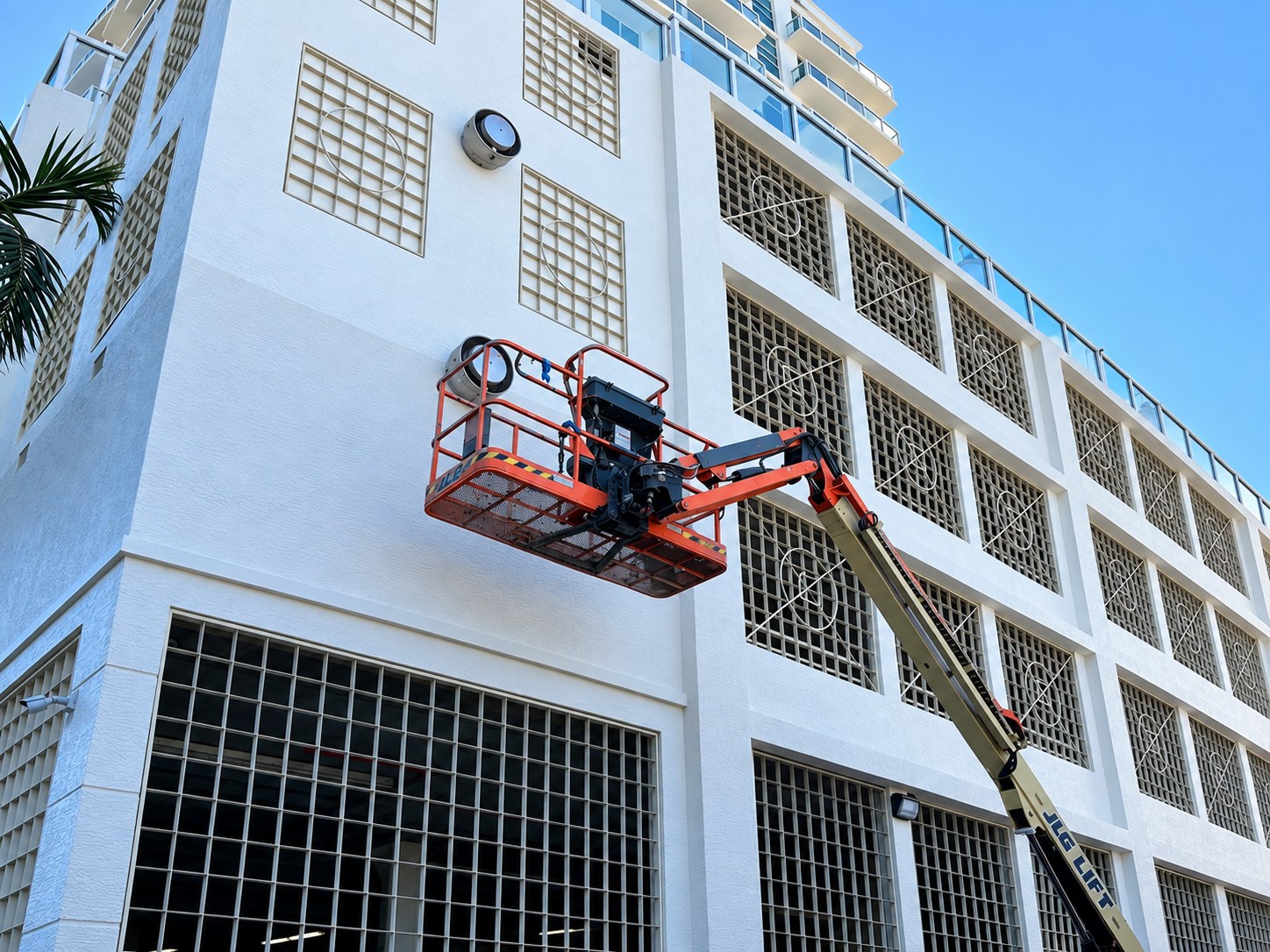 White multi-story building with exterior access lift
